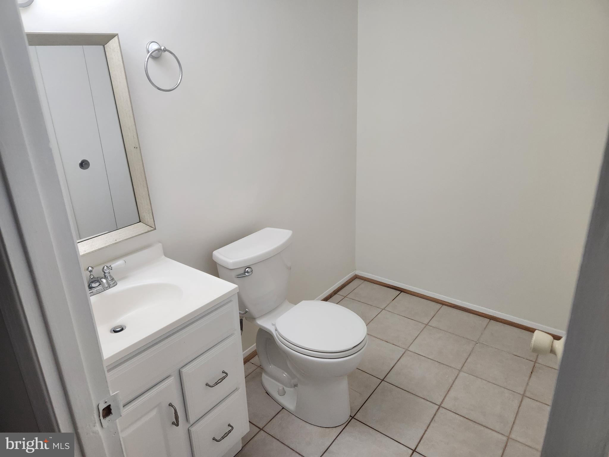 7104 Lasting Light Way Columbia, MD 21045 - Photo 27 of 40 a white toilet sitting next to a bathroom sink