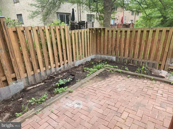 a backyard of a house with a bench