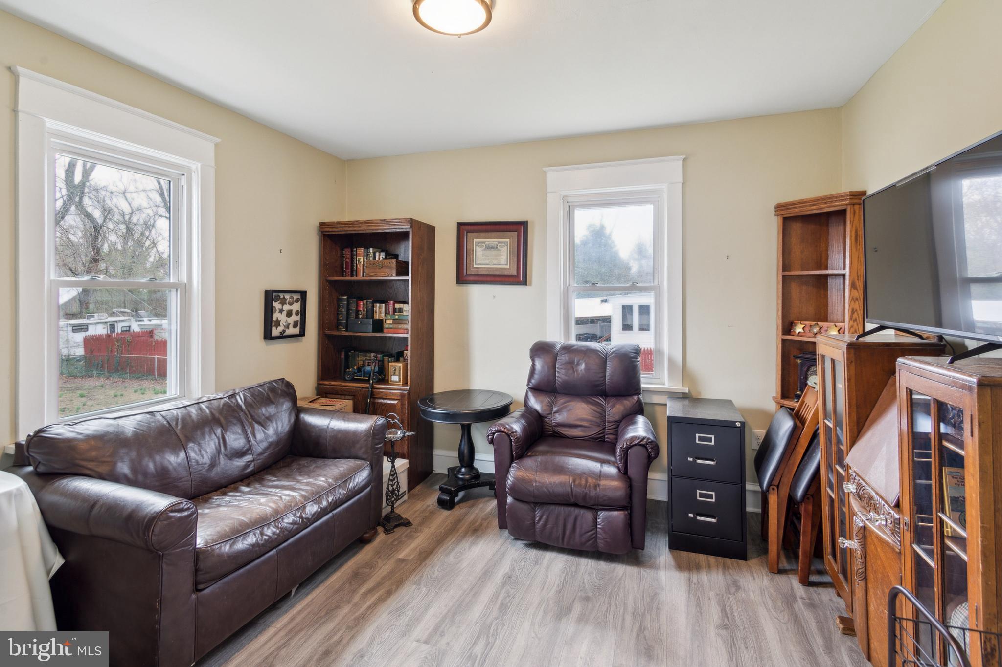 812 Lambert Avenue Mount Ephraim, NJ 08059 - Photo 11 of 24 a living room with furniture a flat screen tv and a bookshelf
