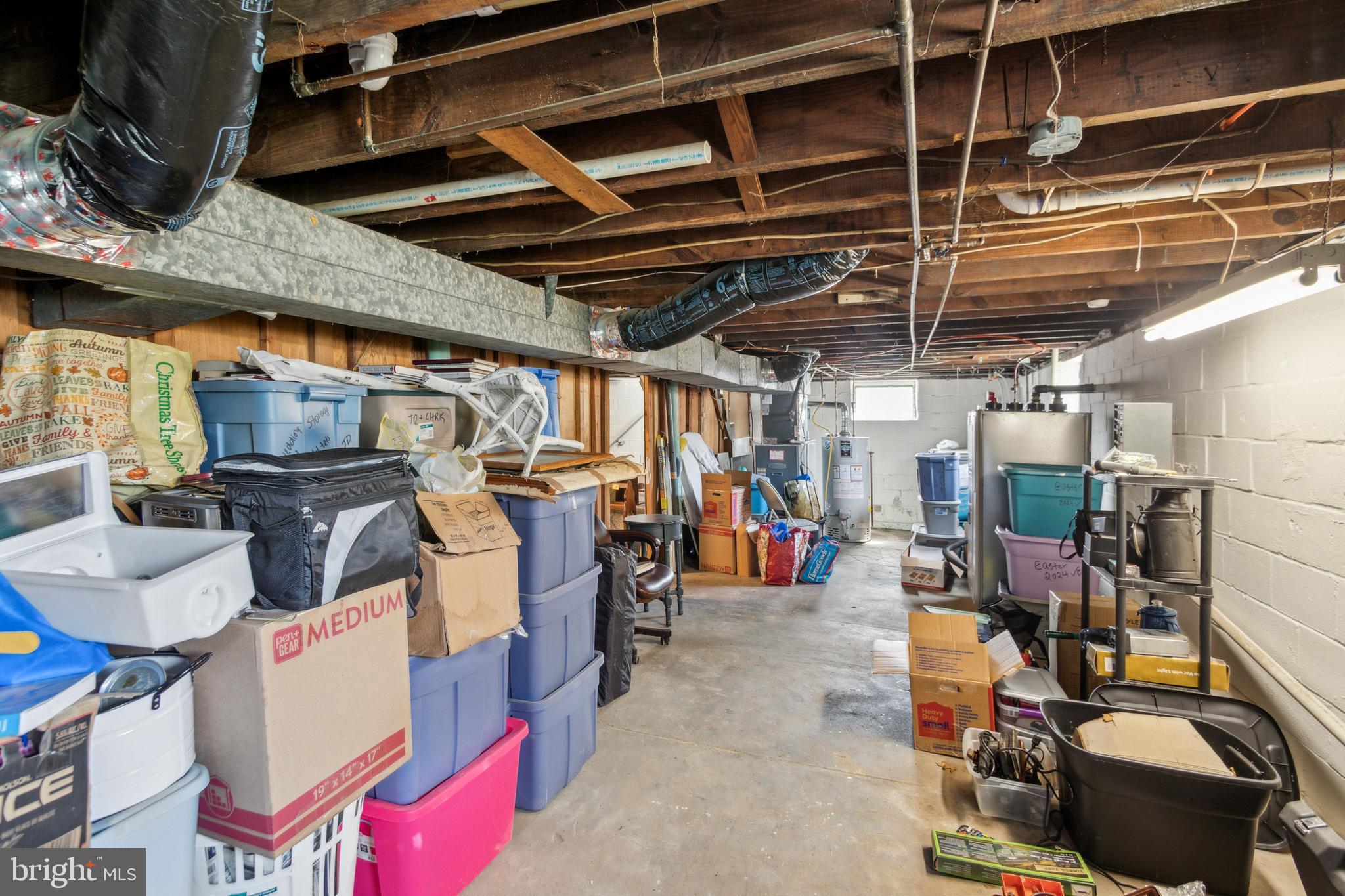 812 Lambert Avenue Mount Ephraim, NJ 08059 - Photo 21 of 24 a view of a storage room with water heater and racks
