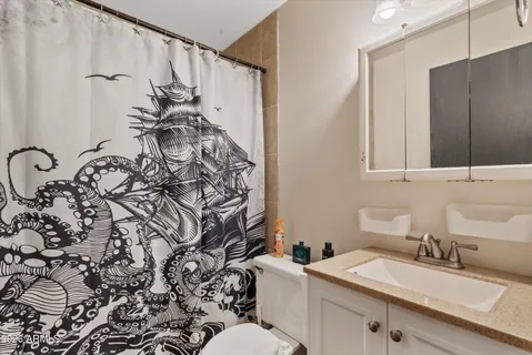 a bathroom with a granite countertop sink and a mirror