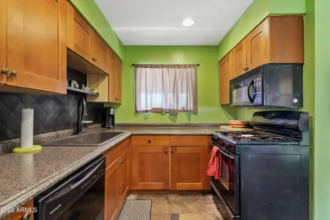 a kitchen with a sink stove top oven and microwave