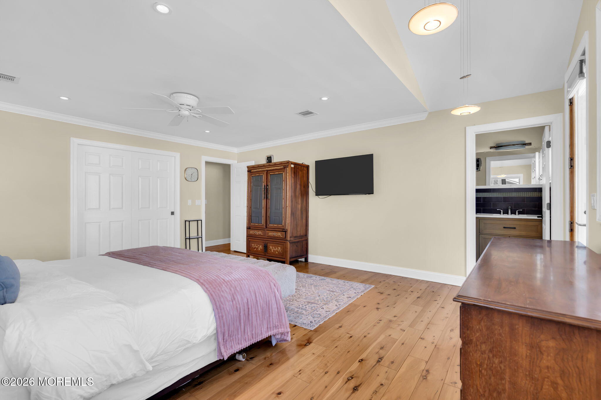 326 Cutter Lane Mantoloking, NJ 08738 - Photo 20 of 35 a spacious bedroom with a bed and a flat screen tv