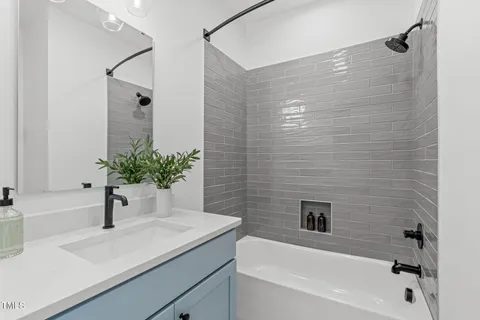 a bathroom with a sink a shower and a mirror