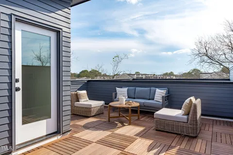 a view of a balcony with furniture