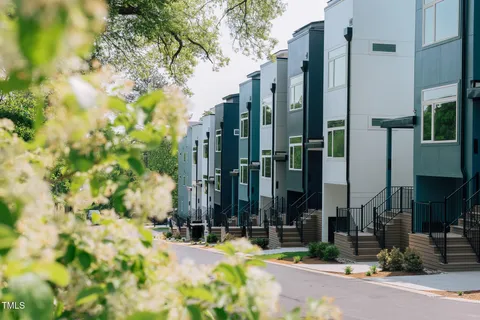 a view of a street with tall house