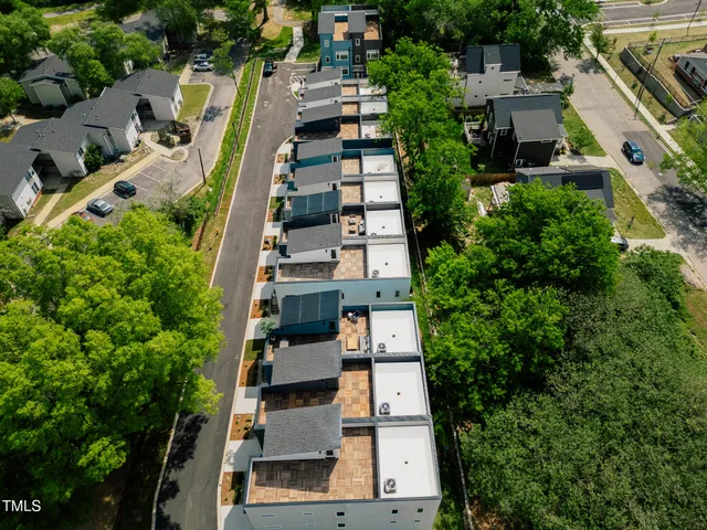 an aerial view of multiple houses with yard