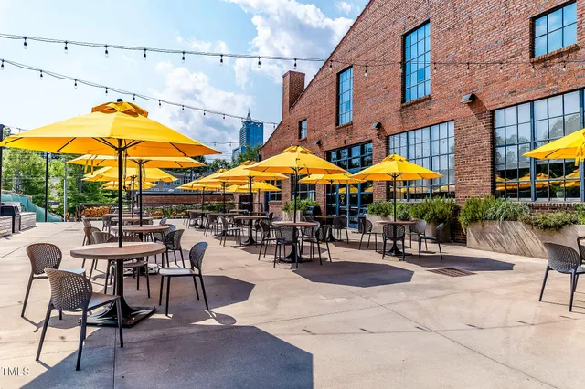 a view of patio with chairs and table under an umbrella