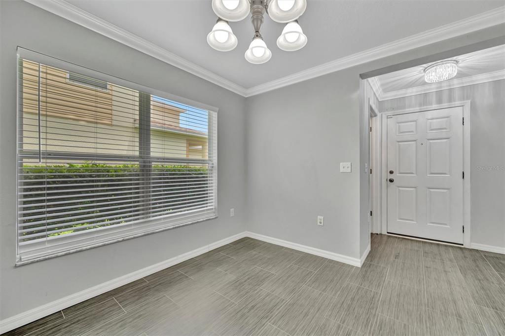 2928 Royal Tuscan Lane Valrico, FL 33594 - Photo 11 of 62 an empty room with wooden floor and windows