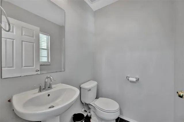 a view of a kitchen with wooden floor and a kitchen space