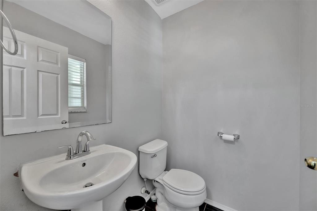 2928 Royal Tuscan Lane Valrico, FL 33594 - Photo 13 of 62 a bathroom with a sink mirror and toilet
