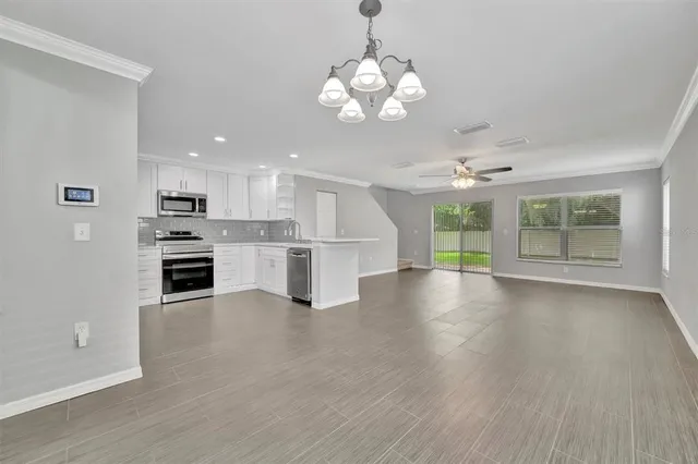 a kitchen with granite countertop white cabinets and white appliances