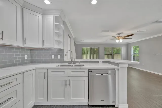 a kitchen with a refrigerator a sink and cabinets