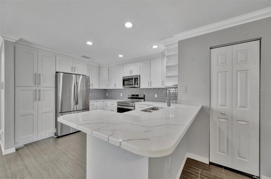 2928 Royal Tuscan Lane Valrico, FL 33594 - Photo 24 of 62 a kitchen with a refrigerator a sink and cabinets