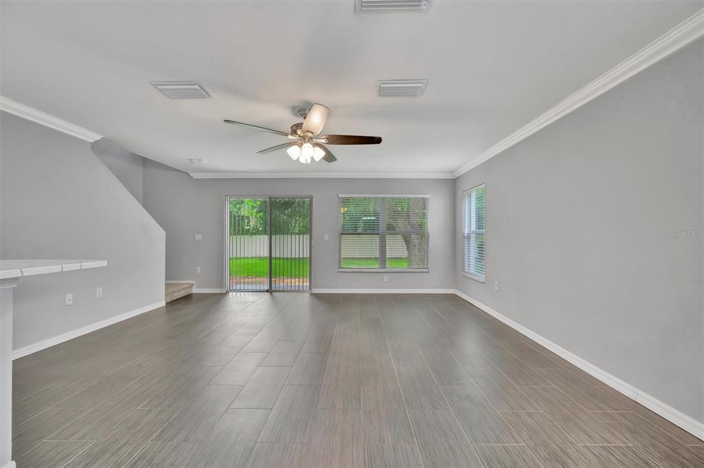2928 Royal Tuscan Lane Valrico, FL 33594 - Photo 26 of 62 a view of an empty room with wooden floor and a window