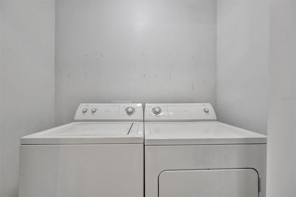 2928 Royal Tuscan Lane Valrico, FL 33594 - Photo 32 of 62 a utility room with dryer and washer