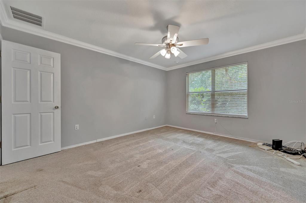 2928 Royal Tuscan Lane Valrico, FL 33594 - Photo 33 of 62 an empty room with windows and fan