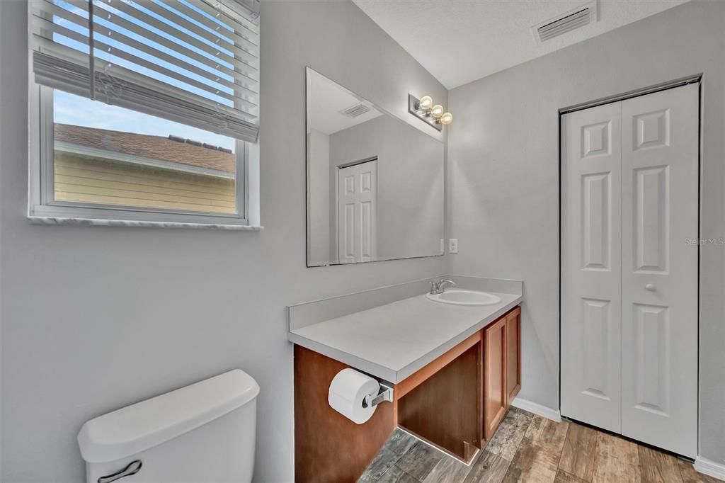 2928 Royal Tuscan Lane Valrico, FL 33594 - Photo 37 of 62 a bathroom with a sink a toilet and vanity