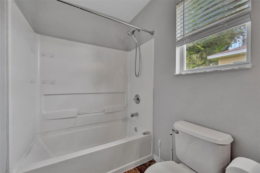 2928 Royal Tuscan Lane Valrico, FL 33594 - Photo 38 of 62 a bathroom with a toilet and a bathtub