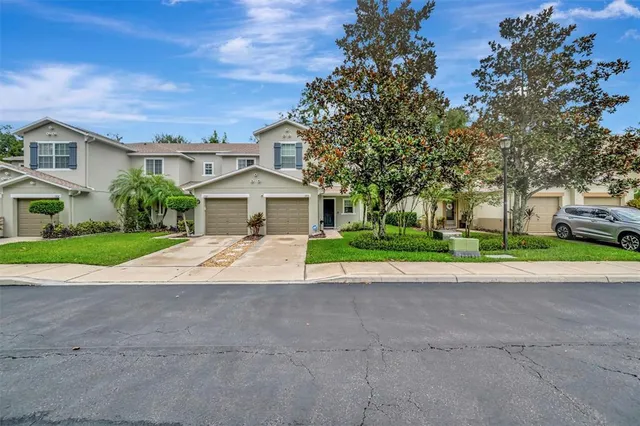 a view of house with yard and green space