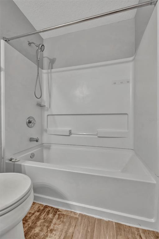 2928 Royal Tuscan Lane Valrico, FL 33594 - Photo 43 of 62 a bathroom with a toilet and a bath tub