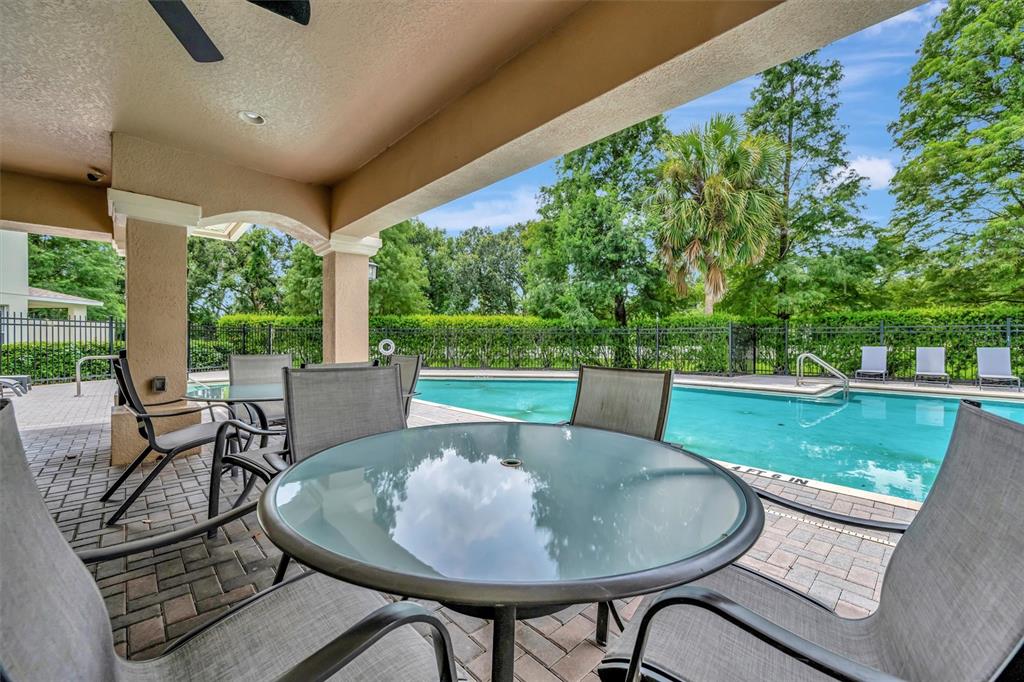 2928 Royal Tuscan Lane Valrico, FL 33594 - Photo 53 of 62 a view of a patio with table and chairs potted plants with wooden floor and fence