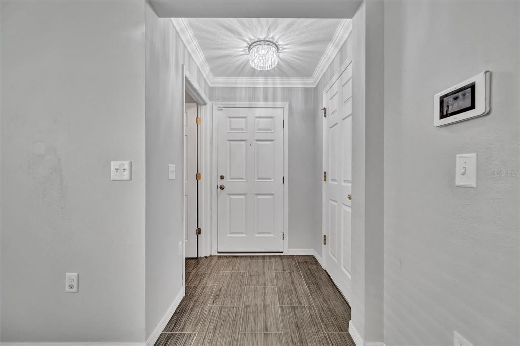 2928 Royal Tuscan Lane Valrico, FL 33594 - Photo 10 of 62 a view of a hallway with wooden floor