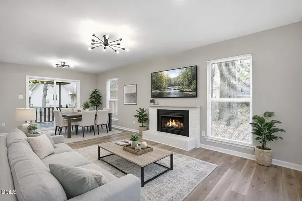 a living room with furniture a chandelier and a fireplace