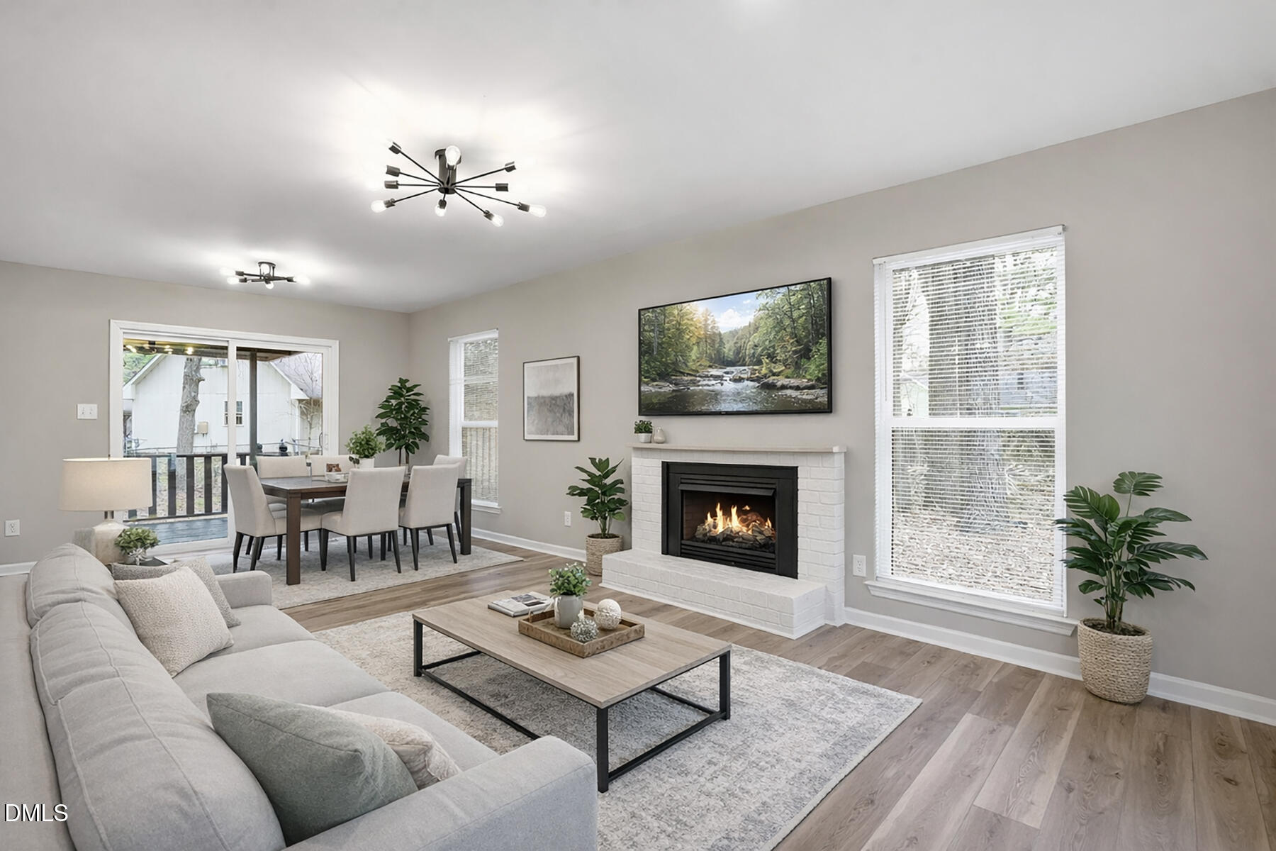 a living room with furniture a chandelier and a fireplace