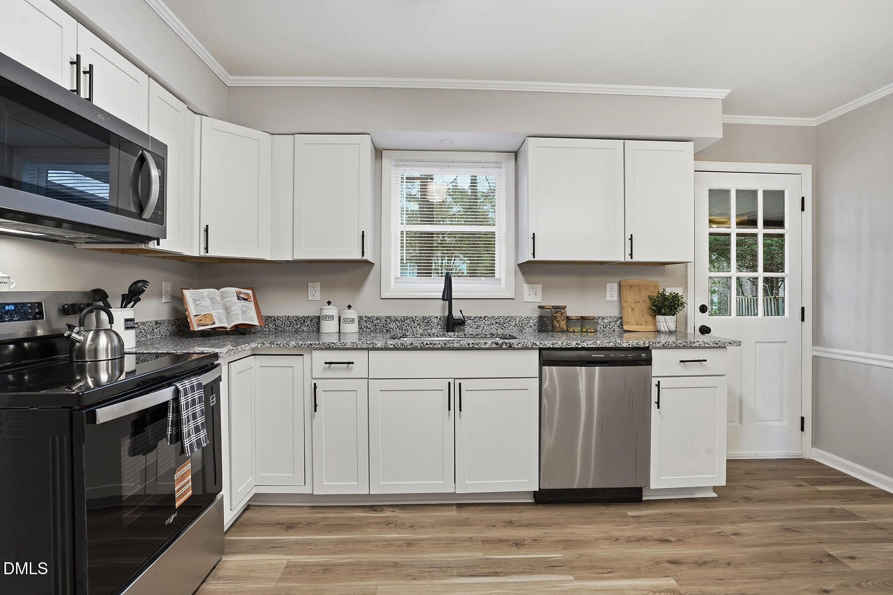 812 Chalk Level Road Durham, NC 27704 - Photo 11 of 31 a kitchen with stainless steel appliances granite countertop a stove a sink and a microwave
