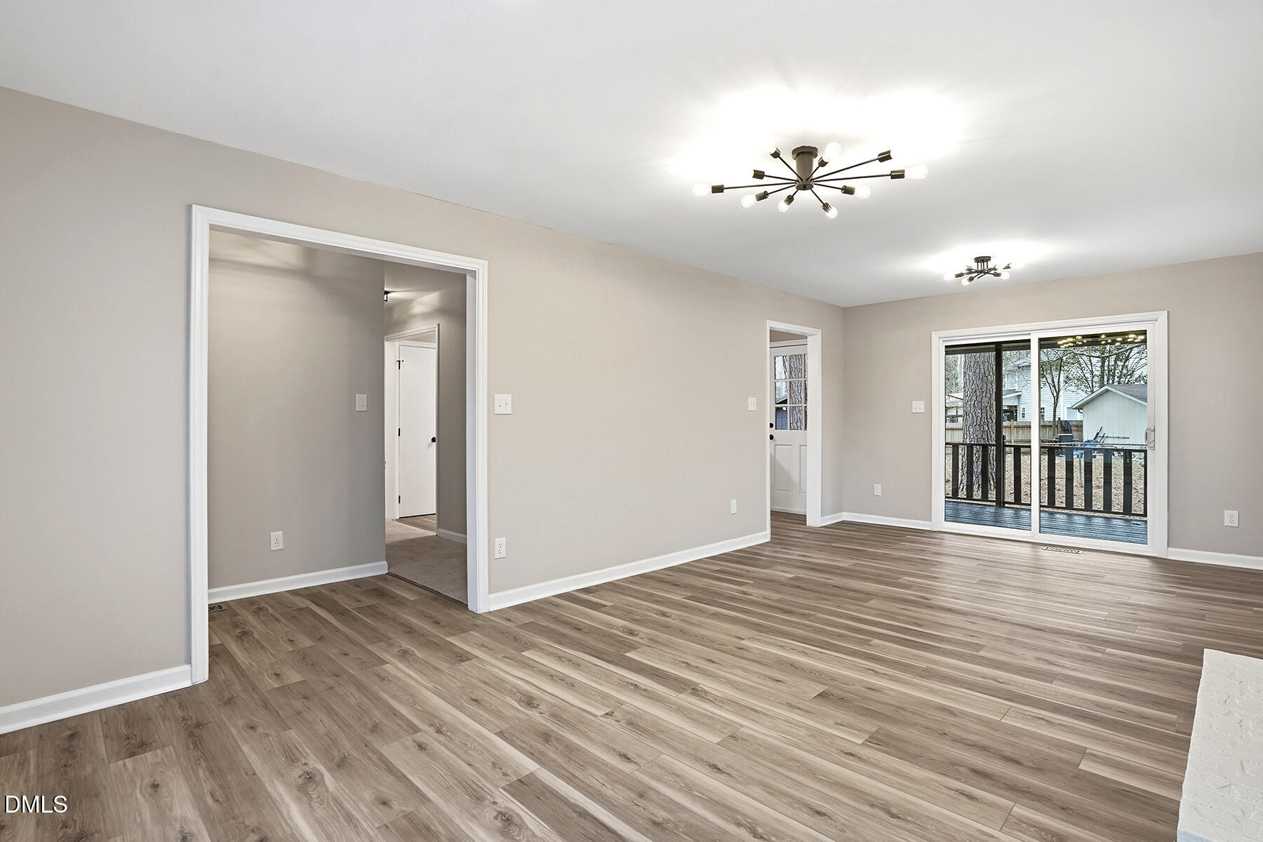 812 Chalk Level Road Durham, NC 27704 - Photo 5 of 31 a view of an empty room with wooden floor and a window