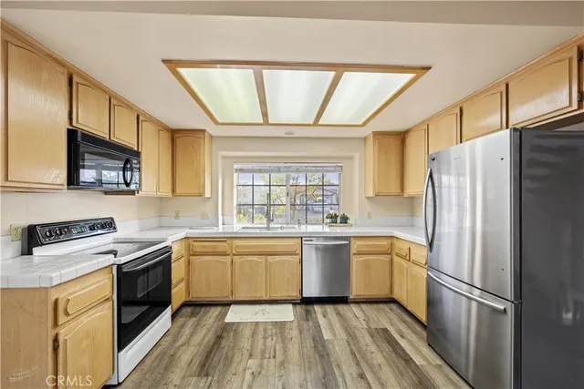 a kitchen with a refrigerator stove and sink