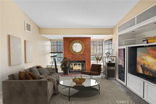 a living room with fireplace furniture and a flat screen tv