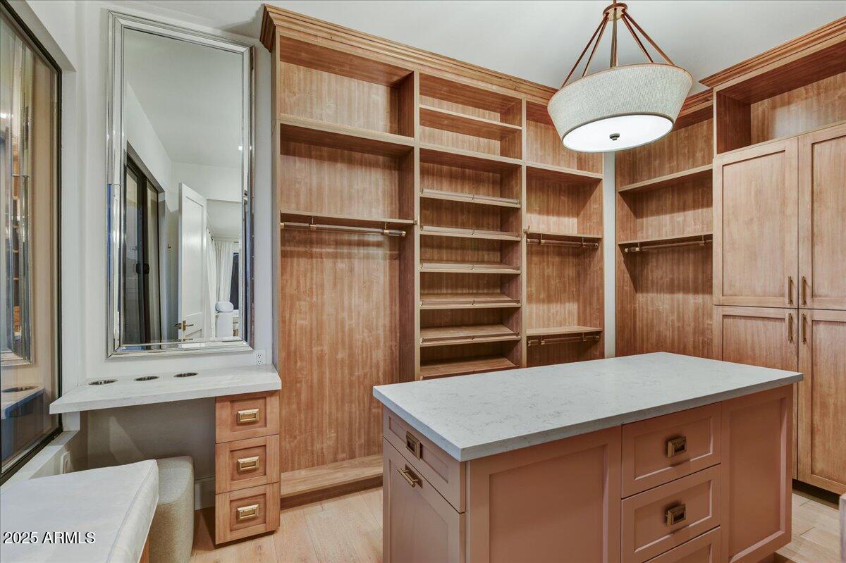 25255 North 90th Way Scottsdale, AZ 85255 - Photo 22 of 41 a kitchen with a cabinets and chandelier