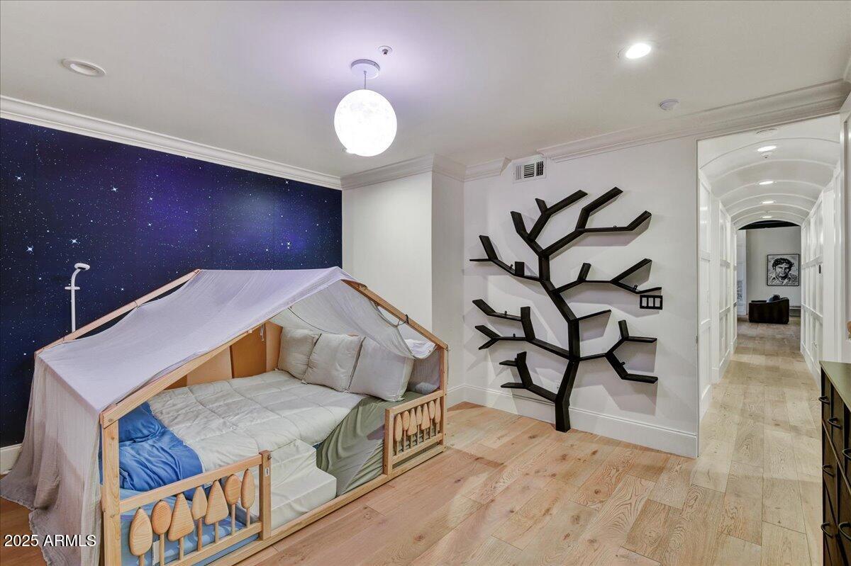 25255 North 90th Way Scottsdale, AZ 85255 - Photo 27 of 41 a spacious bedroom with a bed and a chandelier