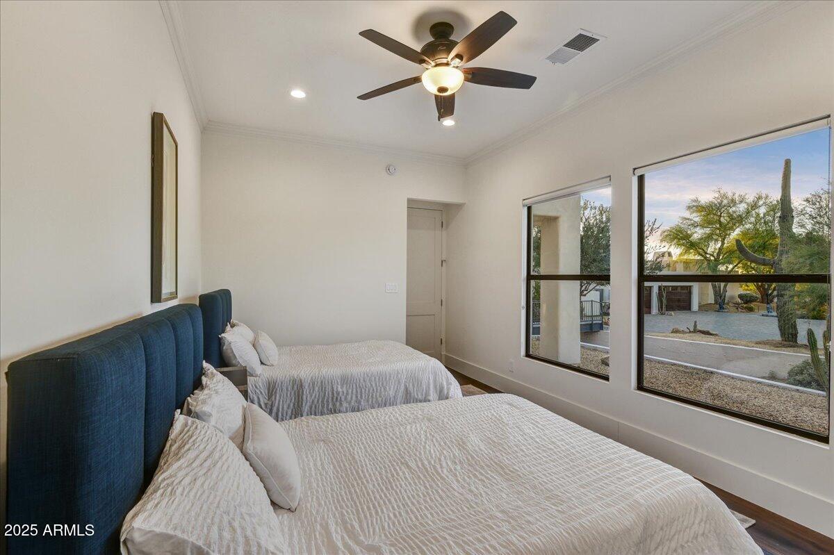 25255 North 90th Way Scottsdale, AZ 85255 - Photo 34 of 41 a bedroom with a large bed and a chandelier