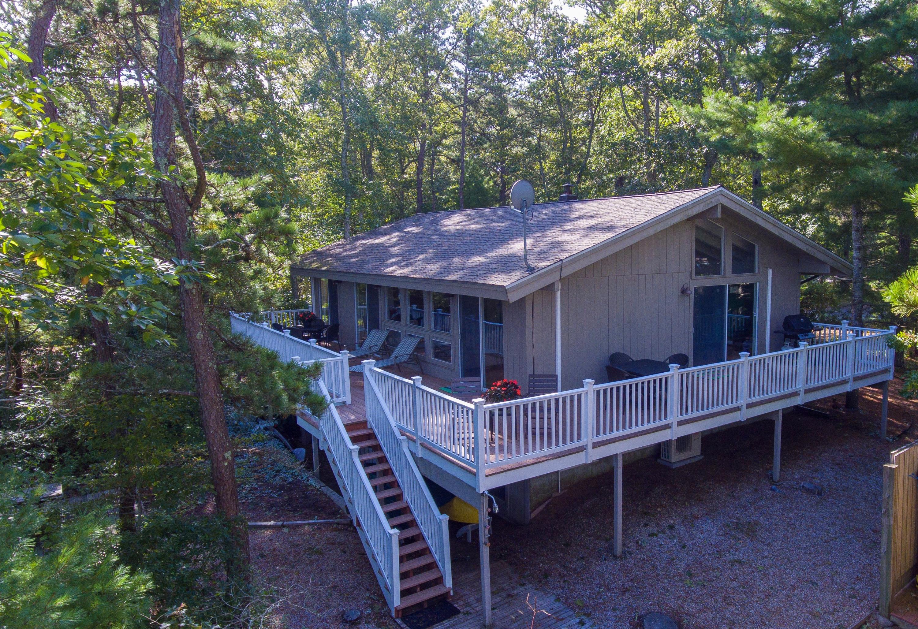 64 Fells Pond Road Mashpee, MA 02649 - Photo 3 of 25 a view of house with a deck and furniture