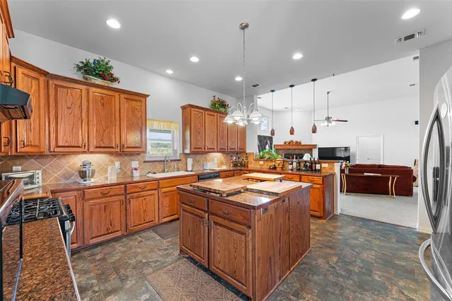 a kitchen with stainless steel appliances a sink stove and cabinets