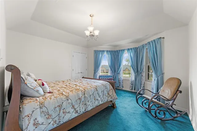 a bedroom with a bed and a chandelier