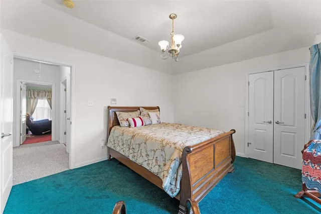 a spacious bedroom with a bed and a couch