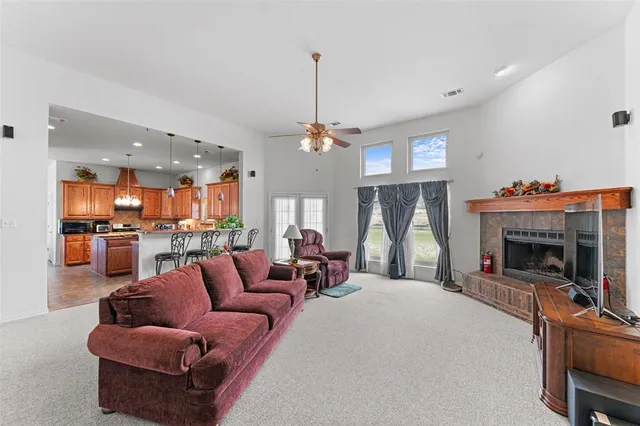 a living room with furniture a fireplace and a flat screen tv