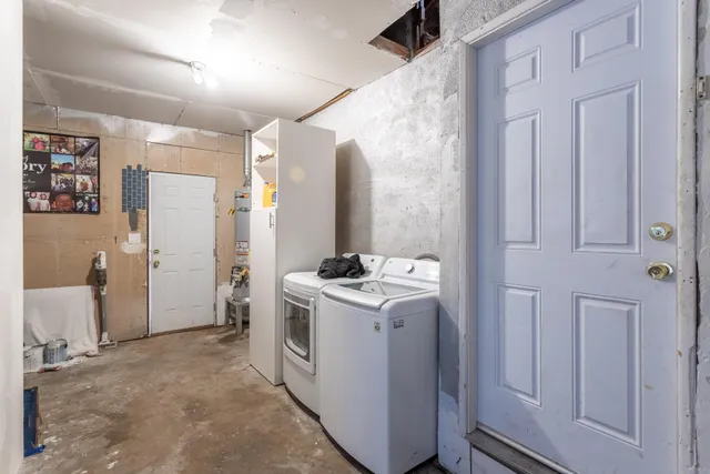 a view of a storage and utility room with washer and dryer