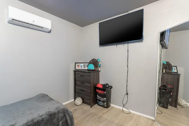 a bedroom with a bed and a flat screen tv