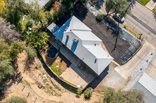 an aerial view of a house with a yard