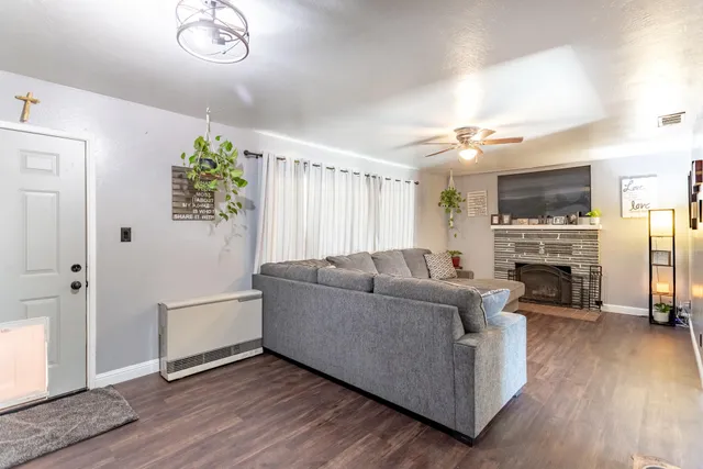 a living room with furniture a fireplace and a chandelier