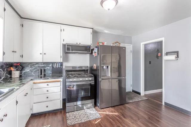 a kitchen with stainless steel appliances a refrigerator sink and cabinets