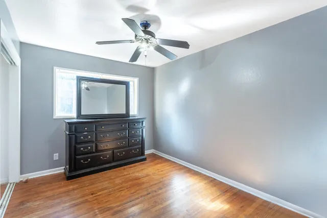 a living room with couch and wooden floor