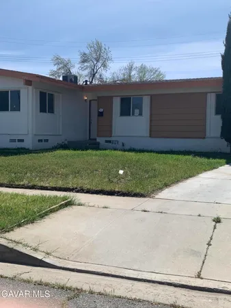 a front view of house with a garden