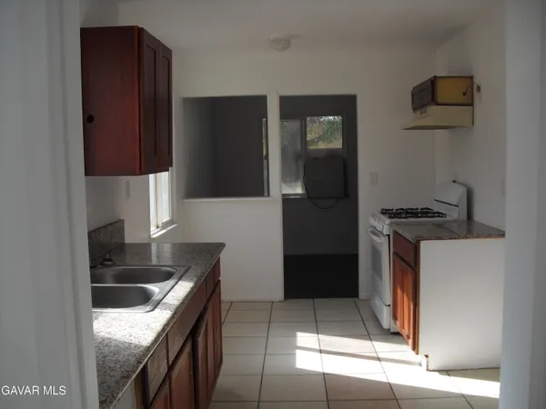 a kitchen with stainless steel appliances granite countertop a refrigerator and a stove