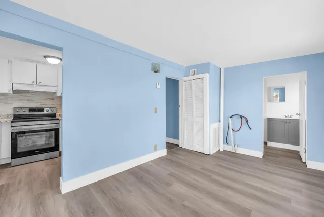 a view of empty room with wooden floor